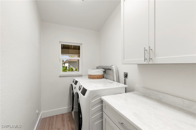 1020 19th St SW, Naples, FL 34117 - laundry area featuring cabinet space, light wood finished floors, and independent washer and dryer