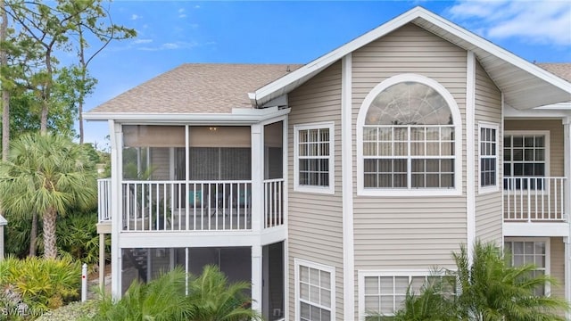 4160 Gunnison Ct Unit 821, Estero, FL 33928 - view of home's exterior featuring a garage, a sunroom, and a shingled roof