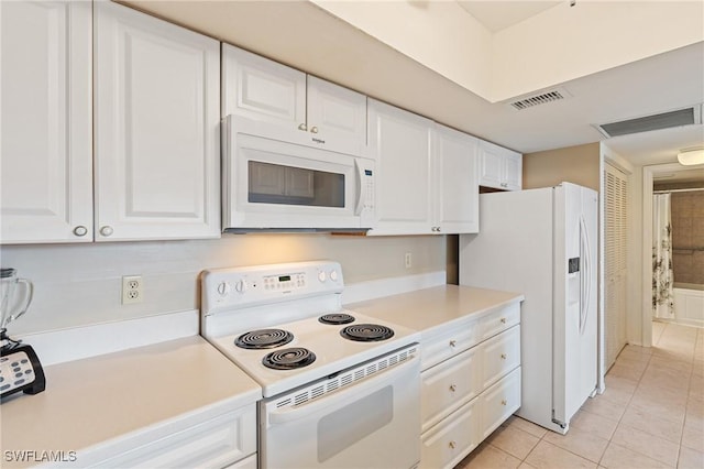4160 Gunnison Ct Unit 821, Estero, FL 33928 - kitchen with white appliances, white cabinetry, light countertops, and light tile patterned floors