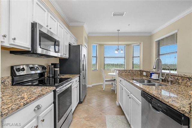9815 Giaveno Ct Unit 1245, Naples, FL 34113 - kitchen featuring appliances with stainless steel finishes, a sink, ornamental molding, white cabinets, and pendant lighting