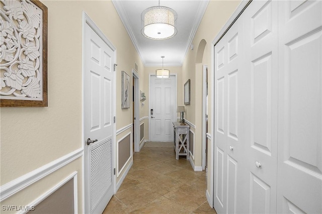 9815 Giaveno Ct Unit 1245, Naples, FL 34113 - hallway featuring crown molding and arched walkways