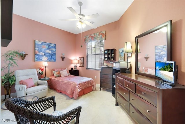 bedroom featuring light colored carpet, baseboards, and ceiling fan