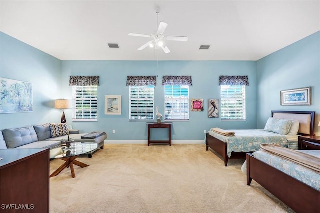 bedroom featuring light carpet, multiple windows, and visible vents