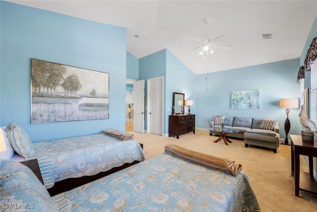bedroom featuring baseboards, carpet flooring, a ceiling fan, visible vents, and high vaulted ceiling