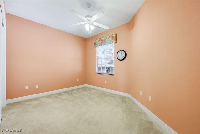 empty room with light carpet, ceiling fan, and baseboards