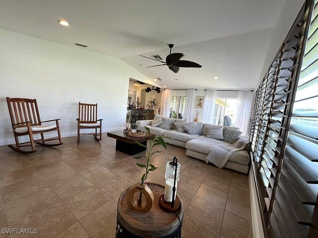 940 SE 20th Ct, Cape Coral, FL 33990 - living area featuring a ceiling fan, baseboards, lofted ceiling, and visible vents