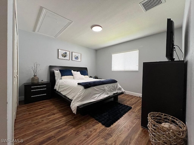 940 SE 20th Ct, Cape Coral, FL 33990 - bedroom featuring baseboards, dark wood-style floors, visible vents, and attic access