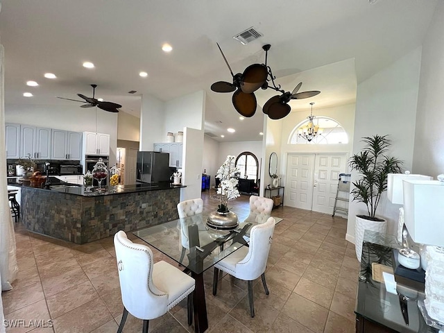 940 SE 20th Ct, Cape Coral, FL 33990 - dining area featuring high vaulted ceiling, visible vents, recessed lighting, ceiling fan with notable chandelier, and light tile patterned floors