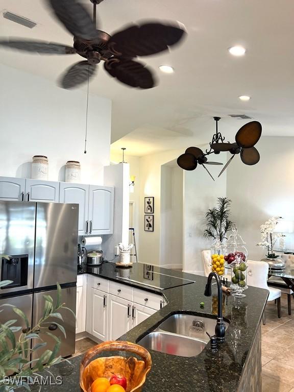 940 SE 20th Ct, Cape Coral, FL 33990 - kitchen featuring visible vents, dark stone counters, recessed lighting, a sink, and stainless steel refrigerator with ice dispenser