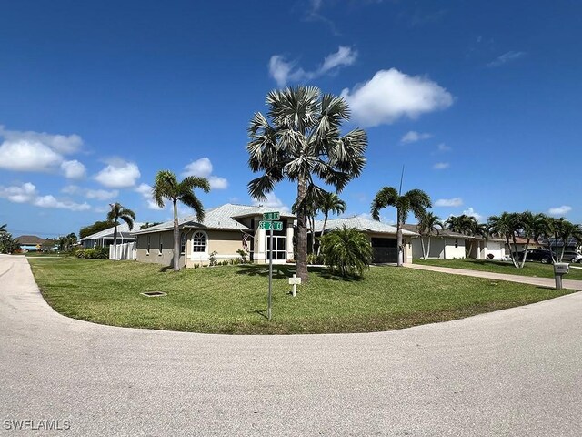 940 SE 20th Ct, Cape Coral, FL 33990 - view of front of property with a front lawn, driveway, and an attached garage
