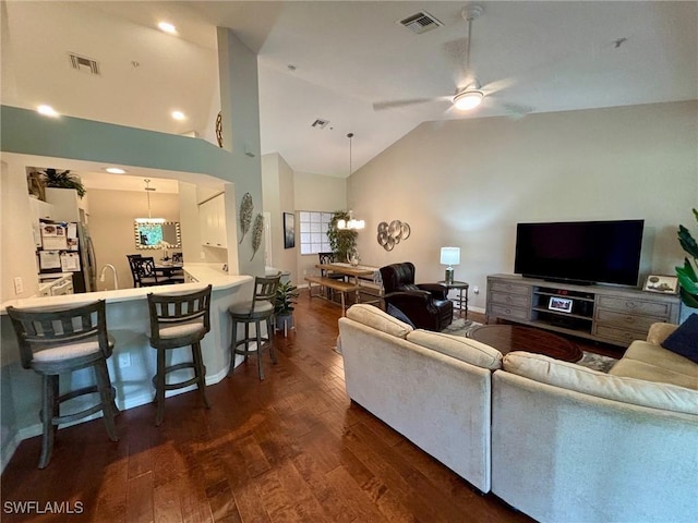 8125 Celeste Dr Unit 5213, Naples, FL 34113 - living room featuring ceiling fan with notable chandelier, high vaulted ceiling, dark wood-type flooring, and visible vents