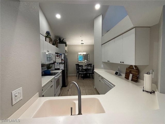 8125 Celeste Dr Unit 5213, Naples, FL 34113 - kitchen featuring white cabinetry, light countertops, white appliances, an inviting chandelier, and a sink