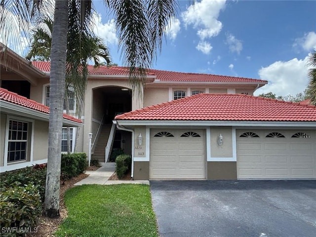 8125 Celeste Dr Unit 5213, Naples, FL 34113 - mediterranean / spanish house with stucco siding, a tile roof, and driveway