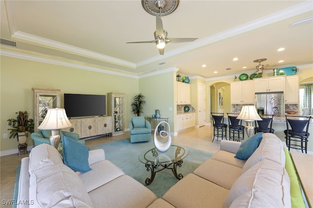11619 Giulia Dr, Fort Myers, FL 33913 - living room featuring light tile patterned flooring, a ceiling fan, visible vents, arched walkways, and ornamental molding
