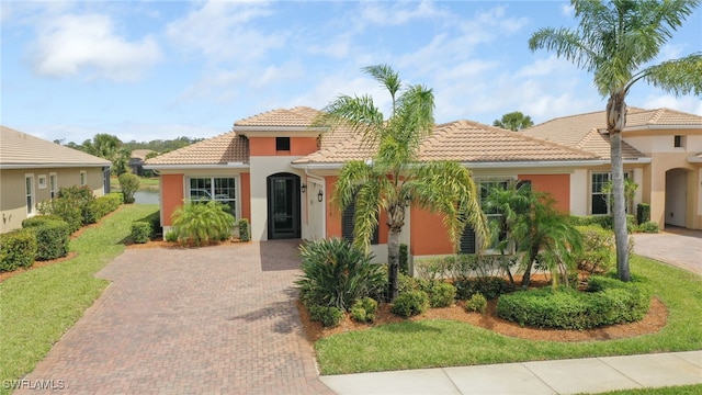 11619 Giulia Dr, Fort Myers, FL 33913 - mediterranean / spanish house with decorative driveway, stucco siding, and a tiled roof