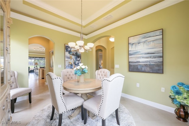 11619 Giulia Dr, Fort Myers, FL 33913 - dining space with an inviting chandelier, arched walkways, and a tray ceiling