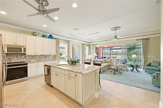 11619 Giulia Dr, Fort Myers, FL 33913 - kitchen with crown molding, a sink, a ceiling fan, appliances with stainless steel finishes, and open floor plan