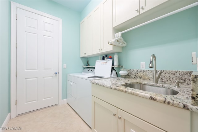 11619 Giulia Dr, Fort Myers, FL 33913 - laundry area featuring a sink, baseboards, light tile patterned floors, independent washer and dryer, and cabinet space