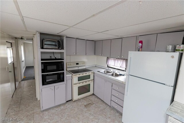 17841 Palm Creek Dr, North Fort Myers, FL 33917 - kitchen featuring a sink, a drop ceiling, white appliances, a toaster, and light countertops