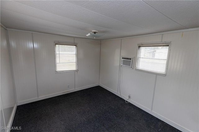 17841 Palm Creek Dr, North Fort Myers, FL 33917 - spare room featuring a wall mounted AC, dark carpet, and a textured ceiling