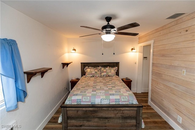 17841 Palm Creek Dr, North Fort Myers, FL 33917 - bedroom with wooden walls, visible vents, a ceiling fan, baseboards, and dark wood-style flooring