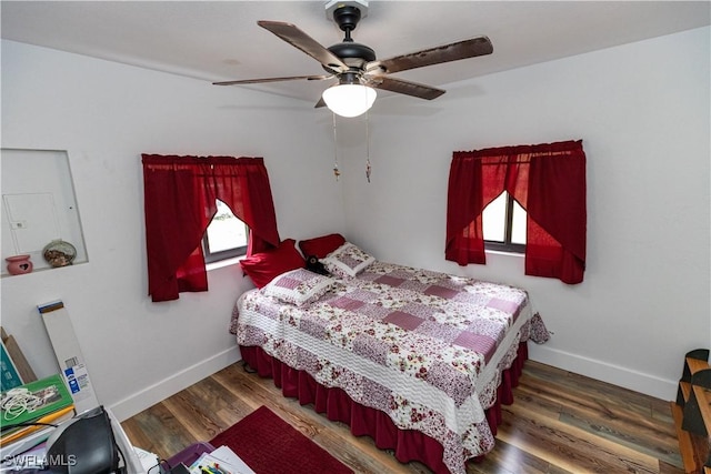 17841 Palm Creek Dr, North Fort Myers, FL 33917 - bedroom with wood finished floors, a ceiling fan, and baseboards