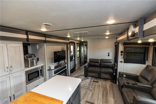 17841 Palm Creek Dr, North Fort Myers, FL 33917 - living area featuring wood finished floors and visible vents