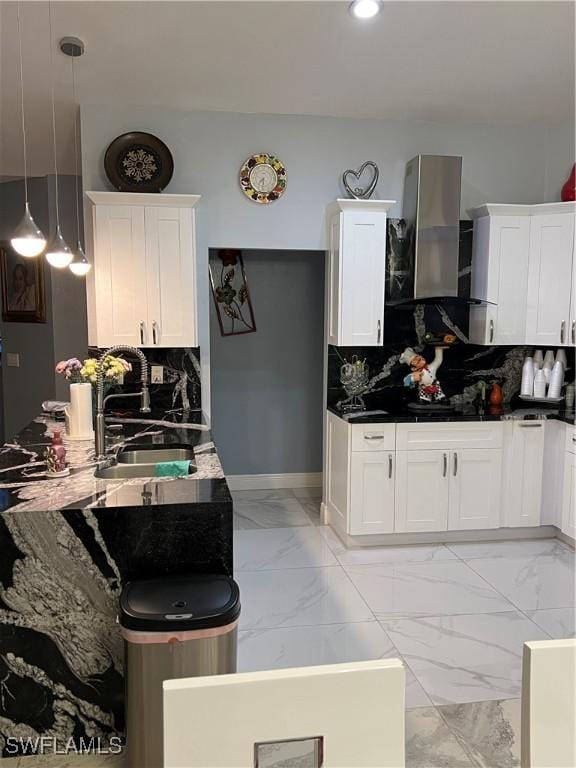 kitchen featuring a sink, tasteful backsplash, ventilation hood, and marble finish floor
