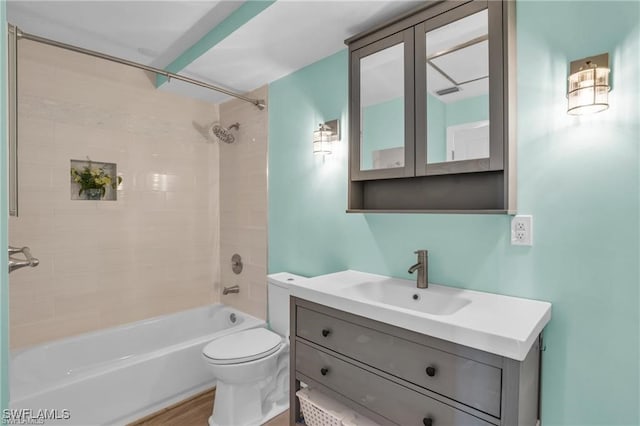 bathroom featuring toilet, shower / tub combination, and vanity