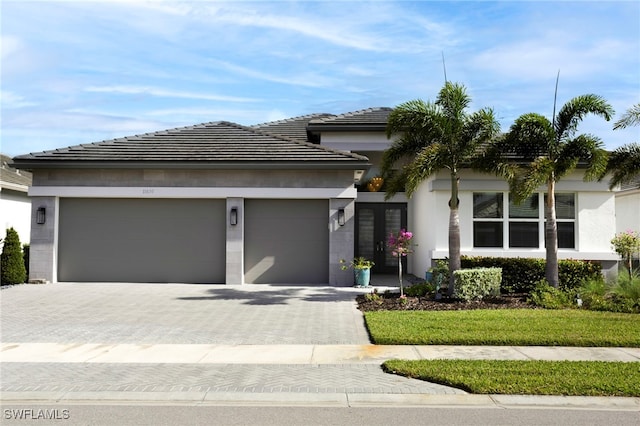 11607 Periwinkle Dr, Naples, FL 34120 - view of front of property with stucco siding, a garage, and decorative driveway