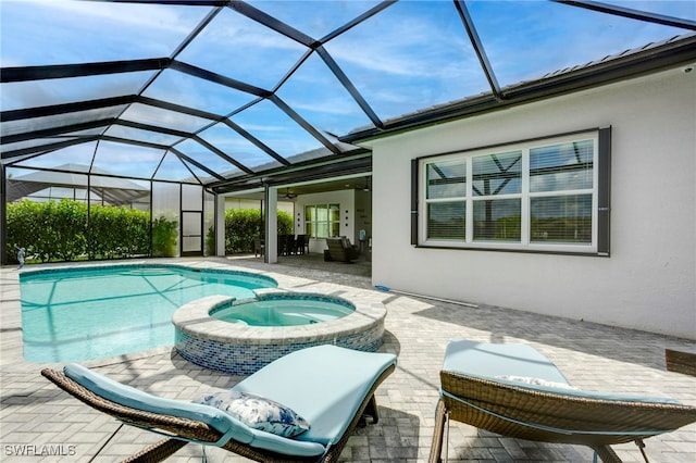 11607 Periwinkle Dr, Naples, FL 34120 - view of swimming pool featuring a patio area, glass enclosure, and a pool with connected hot tub
