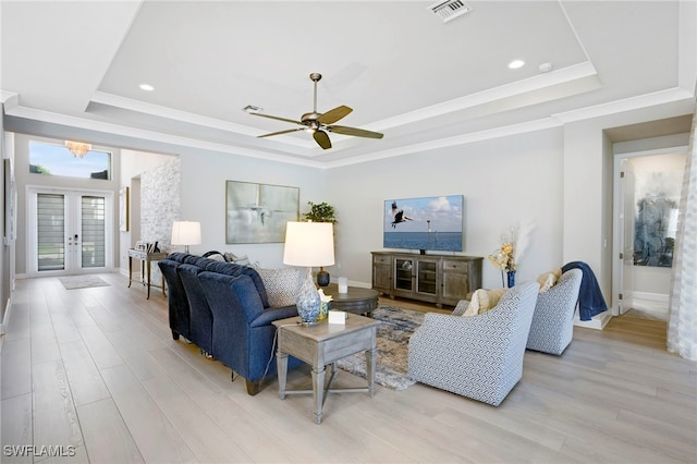 11607 Periwinkle Dr, Naples, FL 34120 - living room featuring french doors, ceiling fan, visible vents, a raised ceiling, and light wood-style floors