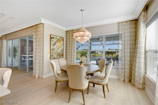 11607 Periwinkle Dr, Naples, FL 34120 - dining area with an inviting chandelier, light wood-style flooring, baseboards, and a healthy amount of sunlight