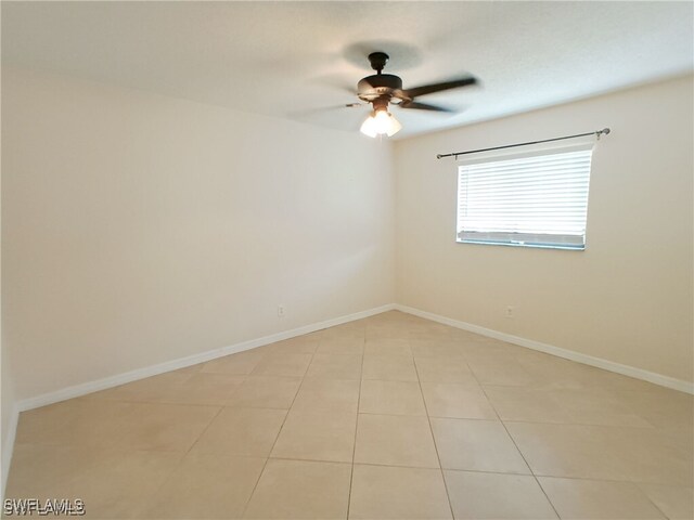 316 SE Santa Barbara Pl, Cape Coral, FL 33990 - spare room featuring light tile patterned floors, ceiling fan, and baseboards