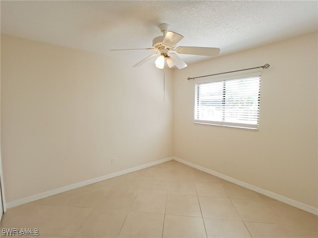 316 SE Santa Barbara Pl, Cape Coral, FL 33990 - spare room featuring baseboards, ceiling fan, and light tile patterned floors