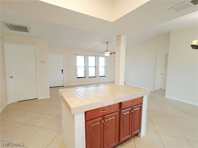 316 SE Santa Barbara Pl, Cape Coral, FL 33990 - kitchen with visible vents, tile countertops, ceiling fan, and light tile patterned floors