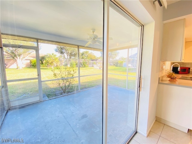 entryway featuring ceiling fan and plenty of natural light