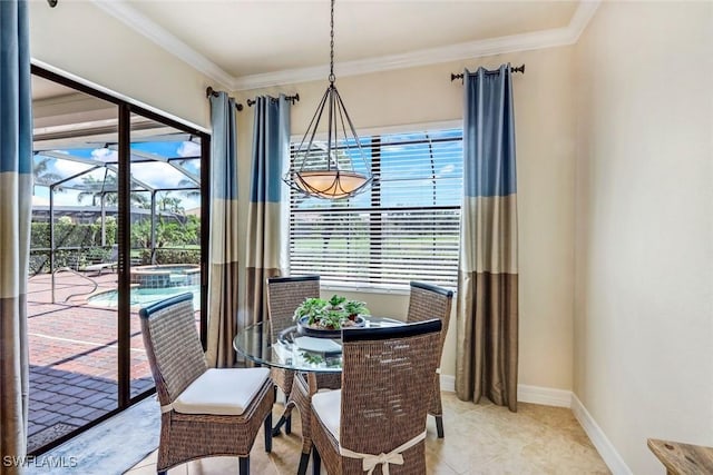 dining space with ornamental molding, baseboards, and plenty of natural light