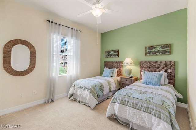 carpeted bedroom with baseboards and a ceiling fan