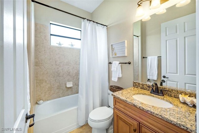 bathroom with shower / bath combo with shower curtain, vanity, and toilet