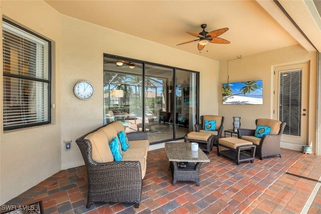 view of patio with an outdoor living space and a ceiling fan