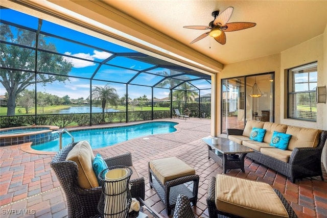 view of pool with a pool with connected hot tub, outdoor lounge area, a ceiling fan, a water view, and a patio