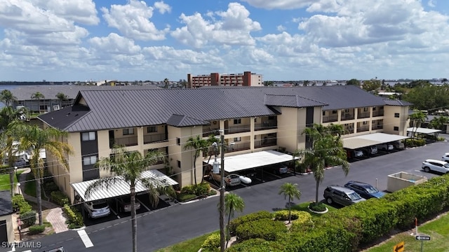 exterior space featuring covered and uncovered parking and a residential view