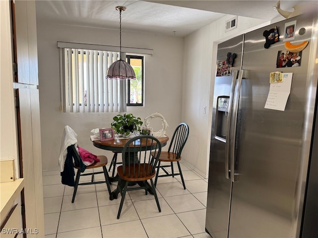 dining space featuring light tile patterned flooring, baseboards, and visible vents