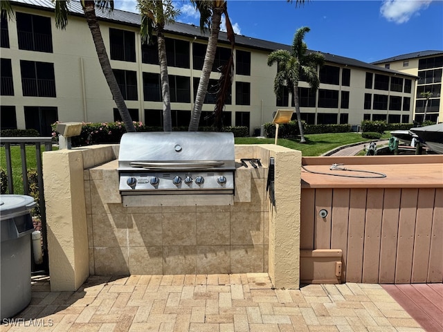 view of patio featuring grilling area, area for grilling, and fence
