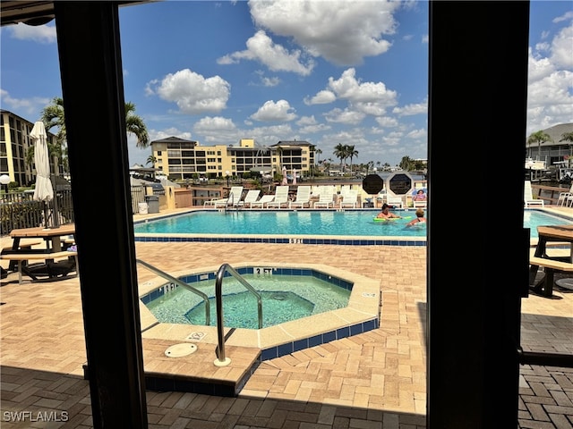 pool featuring a patio and a hot tub