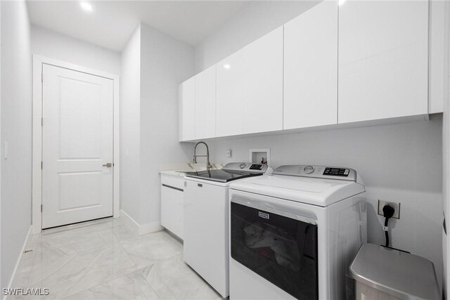 302 NW 1st St, Cape Coral, FL 33993 - washroom with cabinet space, separate washer and dryer, baseboards, and light marble finish floors