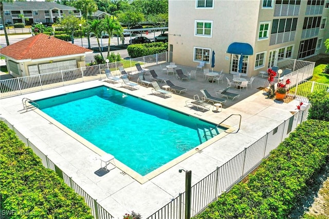 pool with fence and a patio