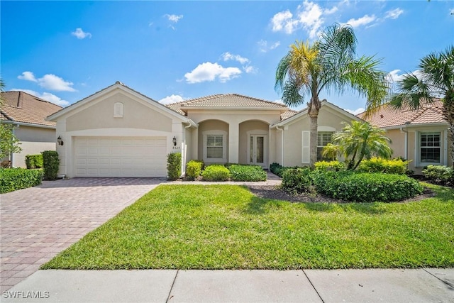 8629 Julia Ln, Naples, FL 34114 - mediterranean / spanish home with stucco siding, decorative driveway, a front lawn, a tile roof, and a garage