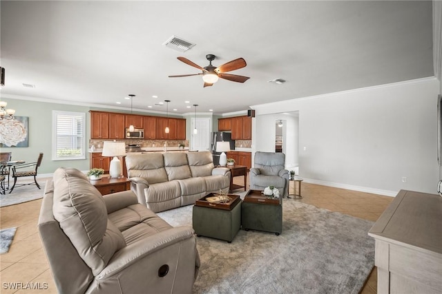 8629 Julia Ln, Naples, FL 34114 - living room featuring ornamental molding, visible vents, light tile patterned floors, and ceiling fan with notable chandelier